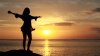 stock-footage-happy-woman-dancing-on-the-beach-at-sunset-with-sea-background.jpg