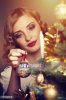 171590576-retro-girl-decorating-a-christmas-tree-gettyimages.jpg