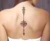woman-with-downward-arrow-tattoo-with-compass.jpg