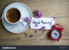 stock-photo-cup-of-coffee-good-morning-note-and-lilac-flower-on-the-wooden-table-189035159.jpg