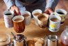 getty_rm_photo_of_man_holding_mulitple_coffee_mugs.jpg
