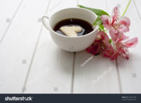 stock-photo-cup-of-coffee-and-flowers-556910185.jpg