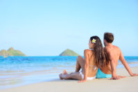 52440-men-and-women-sat-couple-on-the-beach.jpg