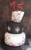 Topsy-turvy 3 tier 15th birthday cake with the number 15 on top in red.JPG