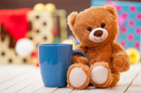 47334974-teddy-bear-with-cup-of-coffee-or-tea-on-christmas-background.jpg