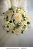 stock-photo-wedding-bouquet-from-beige-roses-on-a-background-of-a-wedding-dress-2818309.jpg