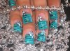 Manicure in turquoise with black flowers and decorations.jpg