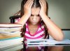 14796082-angry-and-tired-schoolgirl-studying-with-a-pile-of-books-on-her-desk.jpg