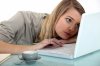 15574120-young-woman-bored-in-front-of-computer.jpg