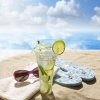 14226338-sunglasses-drink-in-sand-on-beach-at-sea-holiday-concept.jpg